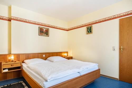 a bedroom with a large white bed in it at Ferienwohnung 2 in Bernkastel-Kues
