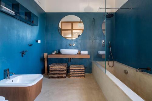 a bathroom with a tub and a sink and a mirror at House in Villa Torto in Monopoli