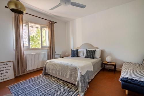 a bedroom with a bed and a ceiling fan at House in Villa Torto in Monopoli