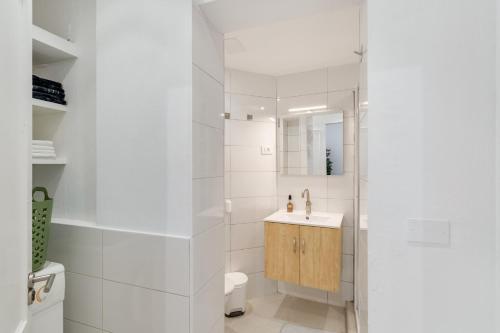 a white bathroom with a sink and a shower at El Doctoral in Vecindario