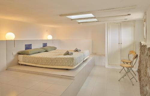 a bedroom with a bed and a chair in it at Finca La Calerita C in Yaiza
