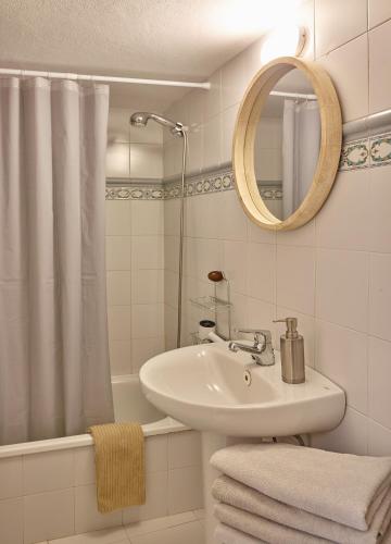 a bathroom with a sink and a shower and a mirror at Finca La Calerita C in Yaiza