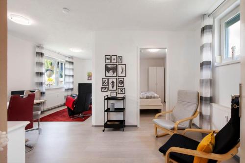 a living room with chairs and a room with a bed at Ferienwohnung Steffi in Laichingen