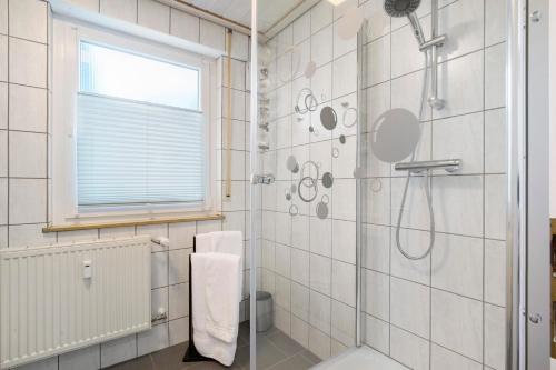 a bathroom with a shower with a glass door at Ferienwohnung Steffi in Laichingen