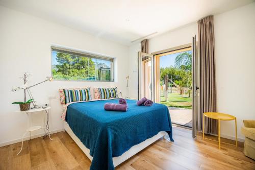 a bedroom with a bed with a blue blanket at Finca Son Montserrat in Llucmajor