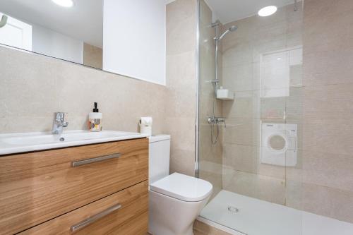 a bathroom with a toilet and a sink and a shower at Brisa Azul in Corralejo