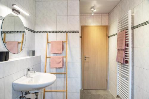 a bathroom with a sink and a mirror at Fewo Maria Grasegger in Grainau