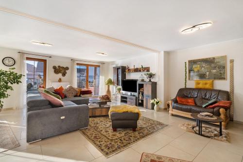 a living room with two couches and a tv at Feriendomizil Berta Benzingen 1 in Winterlingen