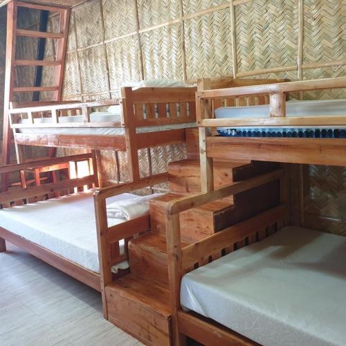 a group of bunk beds in a room at Beachhouse for 15 pax with pavilion in Nasugbu