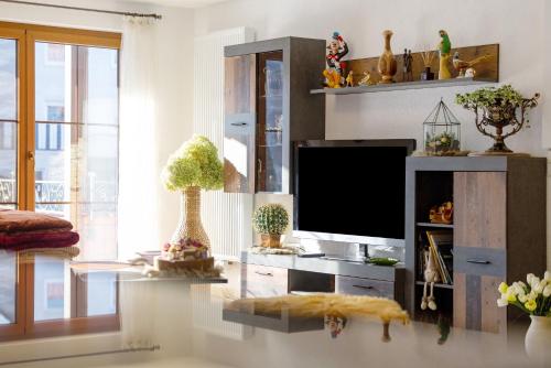 a living room with a flat screen tv on a desk at Feriendomizil Berta Benzingen 1 in Winterlingen