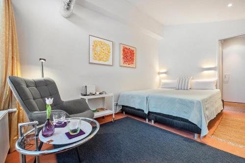 a bedroom with a bed and a table and a chair at room4you in Hemmingen