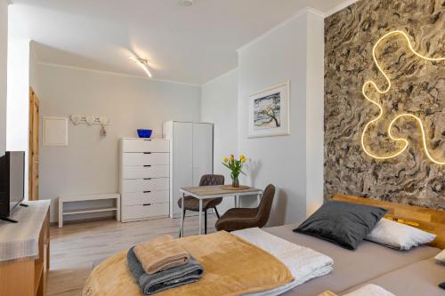a bedroom with a bed and a desk and a table at Ferienwohnung Klosterheide in Lindow