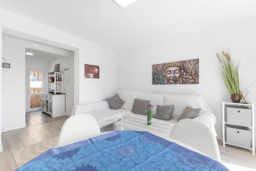 a living room with a white couch and a table at Antogil-mata1 in La Mata