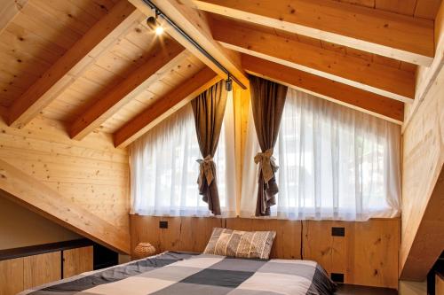 a bedroom with a bed in a wooden room at Dimora Vacanze in Mezzano