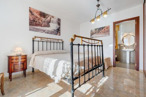 a bedroom with a bed and a table and a mirror at Torre Piquer in Berge
