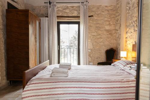 a bedroom with a large bed and a window at Masseria del Ponte in Pretoro