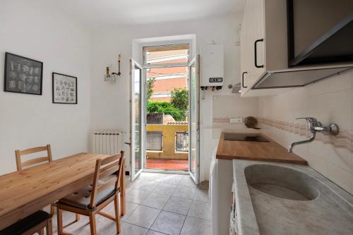 eine Küche mit Spüle, Tisch und Arbeitsplatte in der Unterkunft Casa Rostan in Genua