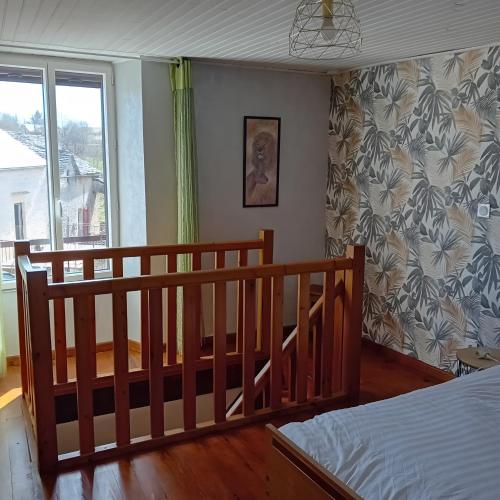 a bedroom with a bed and a window at Gîte Du Recoux in Le Recoux