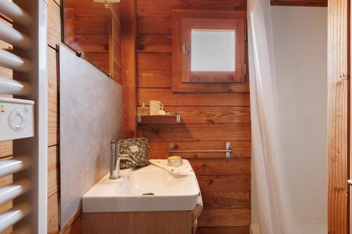 a bathroom with a sink and a window at Chalet confort 18 in Saint-Gervais