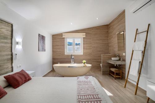 a bathroom with a bed and a tub and a sink at Casa El Buda in Vejer de la Frontera