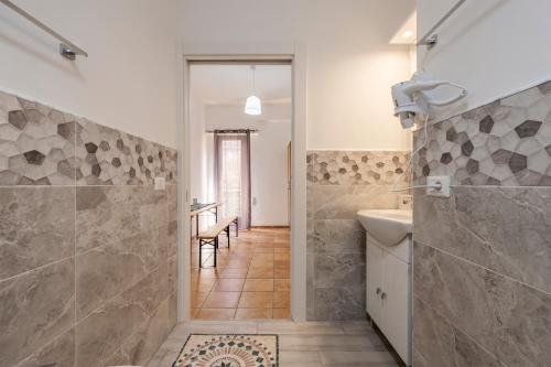 a bathroom with a shower and a toilet and a sink at Sole e Amore in Casteldaccia