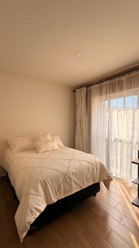 a bedroom with a bed and a large window at Casa Sto Domingo terraza PB 3KM del centro in Oaxaca City