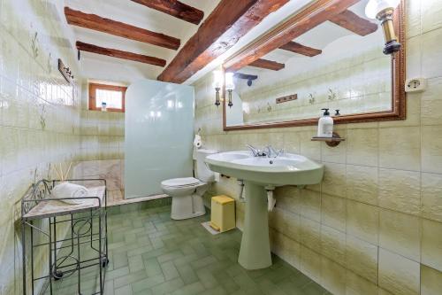 a bathroom with a sink and a toilet at Lo Molí de la Jòrdia in Tortosa