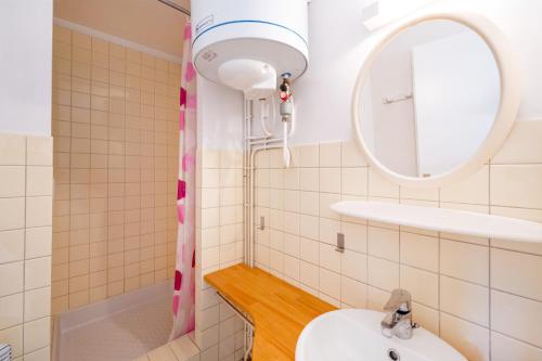 a bathroom with a sink and a mirror at Les Mimosas - Appartement 07 in Cazaubon