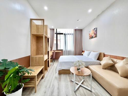 a small room with a bed and a couch at Aurora Homestay in Hanoi