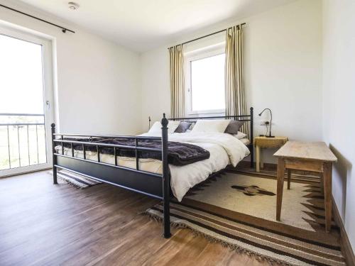 a bedroom with a bed and a large window at Ferienwohnung Im Weiler, 70 Qm in Winterlingen
