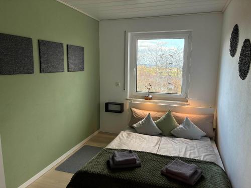 a small bedroom with a bed and a window at Ferienwohnung Janz Jürgen und Bianka in Oberelsbach