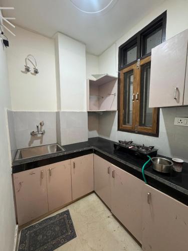 a kitchen with white cabinets and a sink at Spiritual Oasis in Rishīkesh