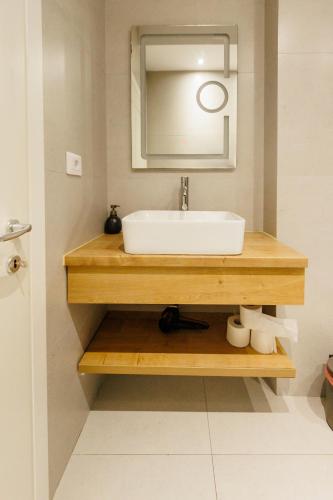 a bathroom with a sink and a mirror at Confort Apartment in Iaşi