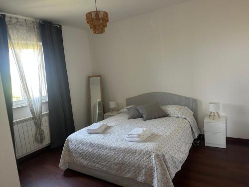 a bedroom with a bed with towels on it at casa Ludovica-vista mare-giardino privato in Trieste