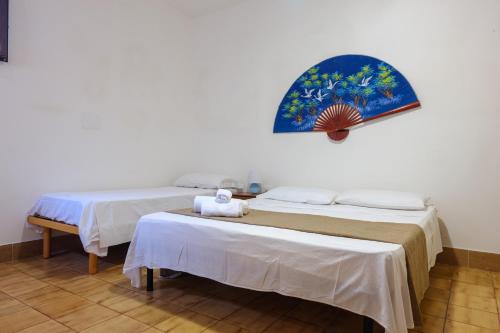 two beds sitting next to each other in a room at Villa Assunta in Lecce