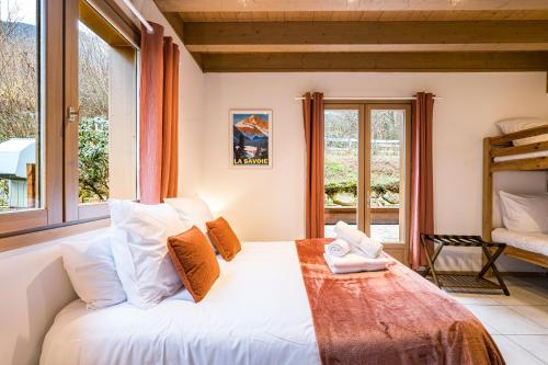 a bedroom with a large bed and a window at Chalet Coeur de Savoie in Cléry