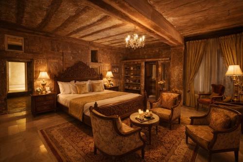 a bedroom with a bed and a table and chairs at The Blue House in Jodhpur
