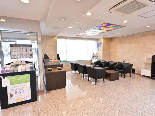 a waiting room with black chairs and a table in a store at Sanco Inn Kuwana Ekimae in Kuwana