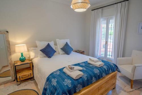 a bedroom with a bed with two towels on it at vituco34 in Mijas