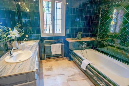 a bathroom with a tub and a sink and a bath tub at vituco34 in Mijas