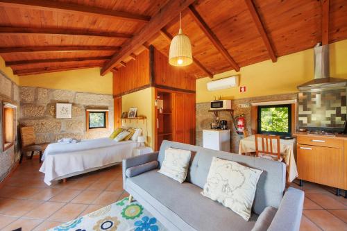 a living room with a couch and a bed at Casa de Andrães Loft Heras in Marco de Canaveses