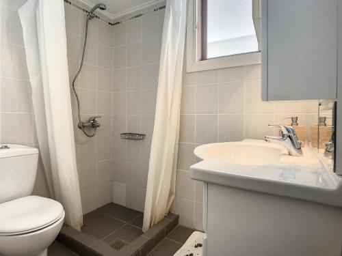 a bathroom with a sink and a toilet and a shower at Beach Villa, Swimming pool for 8 in Thermisía