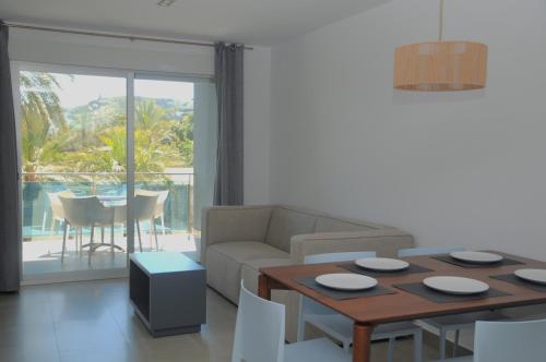 a living room with a couch and a table at Apartamentos Bravosol in Denia