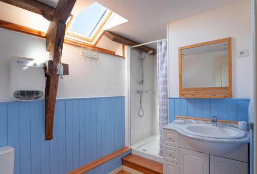 a bathroom with a sink and a mirror at Domaine de Lestroué - Île de Groix in La Vraie-Croix
