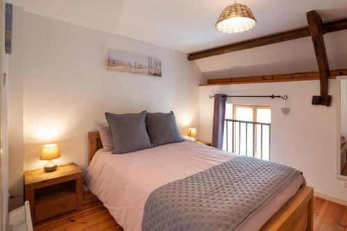 a bedroom with a large bed and a window at Domaine de Lestroué - Île de Groix in La Vraie-Croix