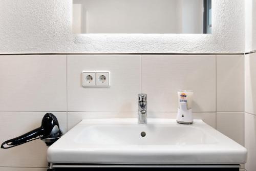 a white sink in a bathroom with a mirror at Fewo Walk in Salem