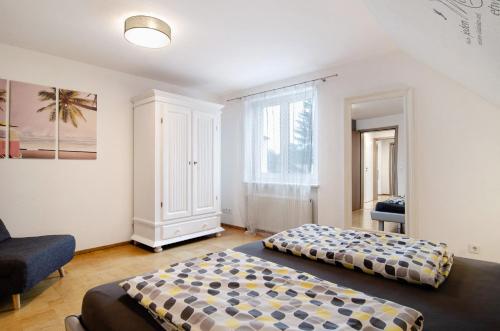 a bedroom with two beds and a chair and a window at Fewo Walk in Salem