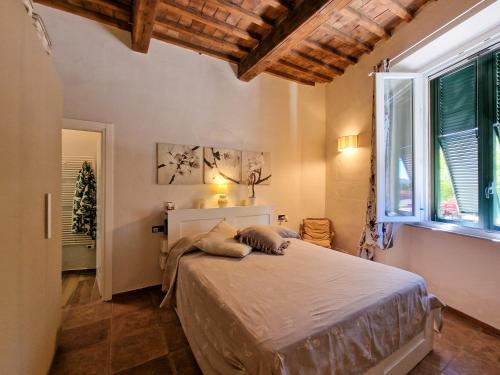 a bedroom with a bed and a large window at Casa Caterina in Portoferraio