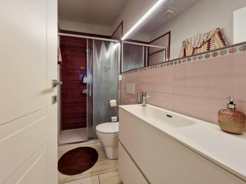 a bathroom with a toilet and a sink and a shower at Casa Caterina in Portoferraio