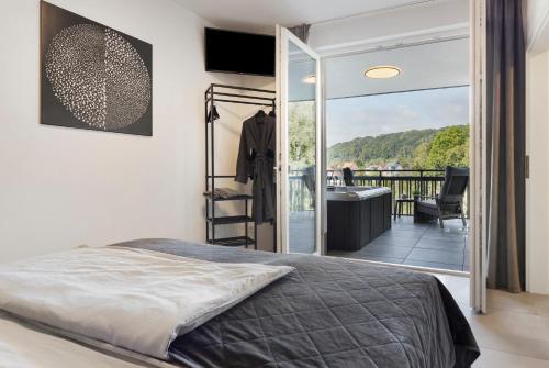 a bedroom with a bed and a balcony at Egge Resort 7e mit Whirpool u Sauna in Altenbeken
